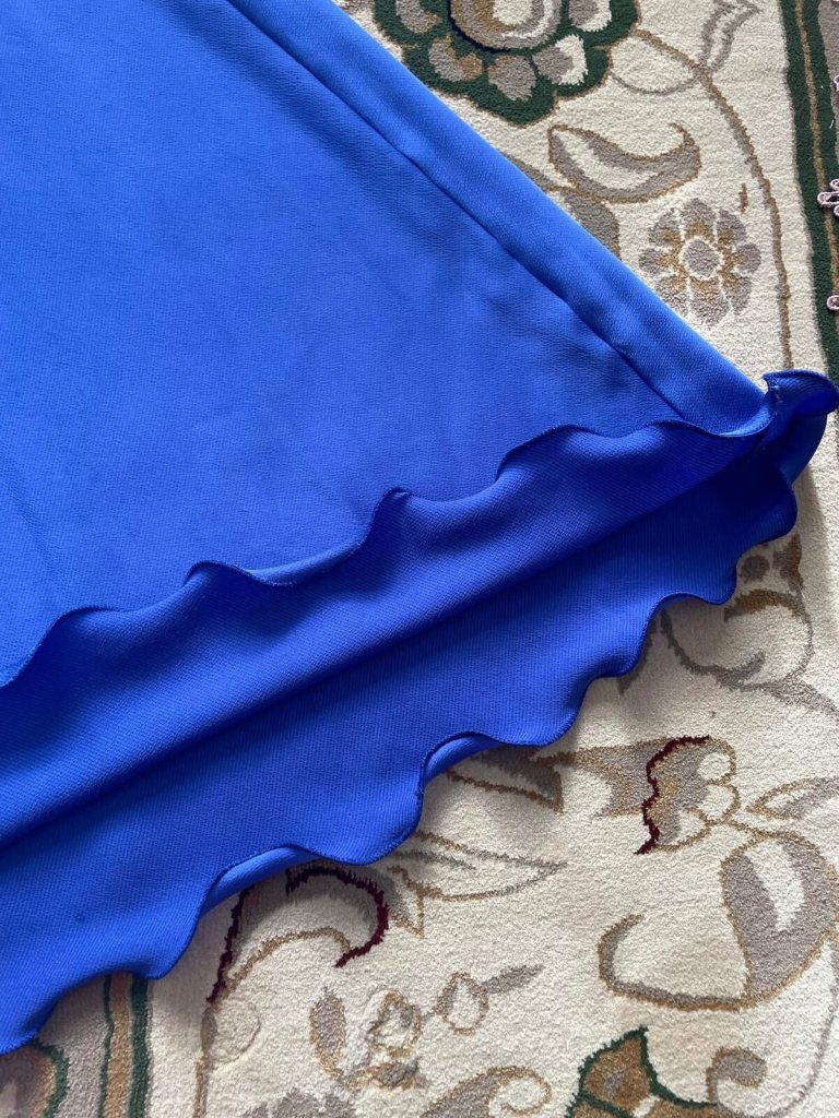 Detailed close-up of the finished edge on a royal blue formal dress